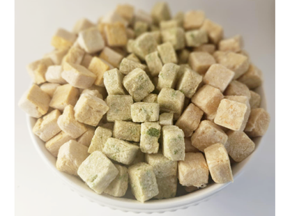 Chicken and Carrot, Chicken Green Bean, Chicken Sweet Potato in a white bowl. Crunchy dog treats in cube shape for easy training, rewards, and meal toppers. Raw diet friendly Pet Treats.